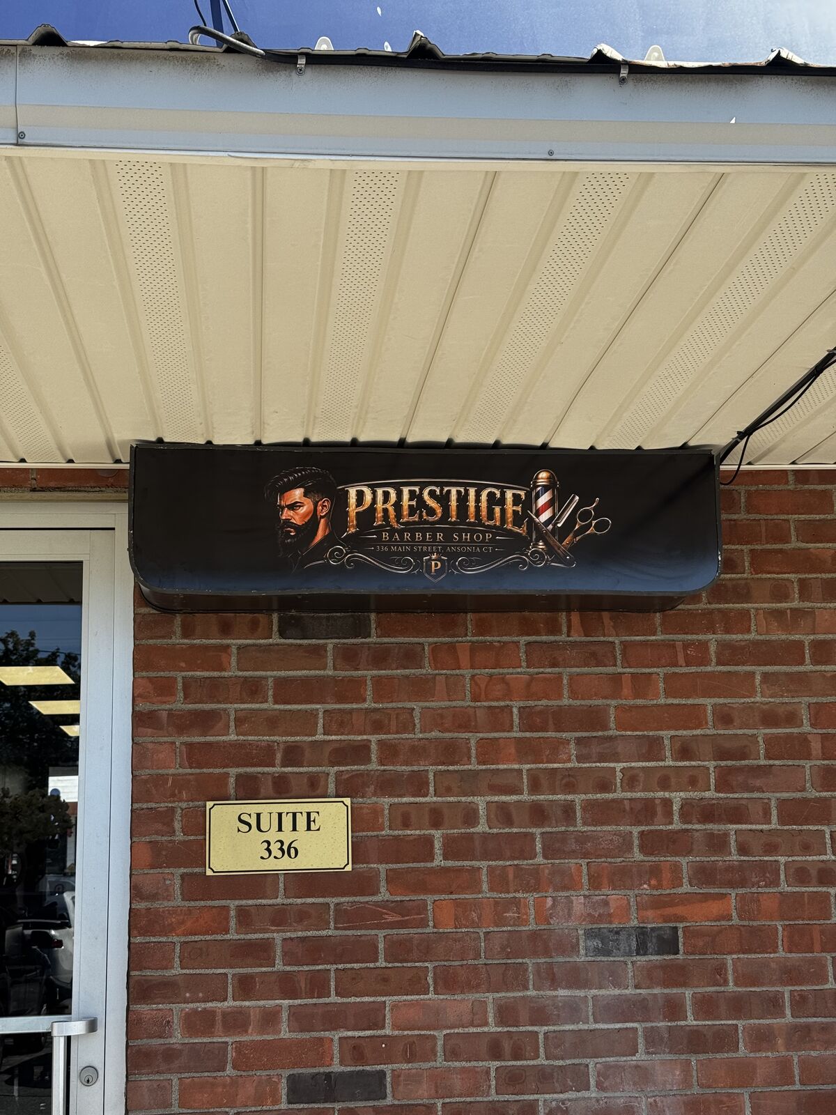 Prestige Barbershop branded sign at the suite entrance